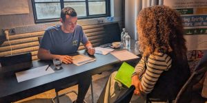 Camp director interviewing an applicant at a hiring fair